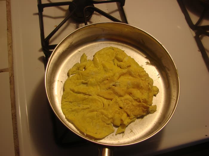 Using a spatula, I peeled at the edges of the omelet and tilted the pan, allowing the runny interior to fill in the gaps.