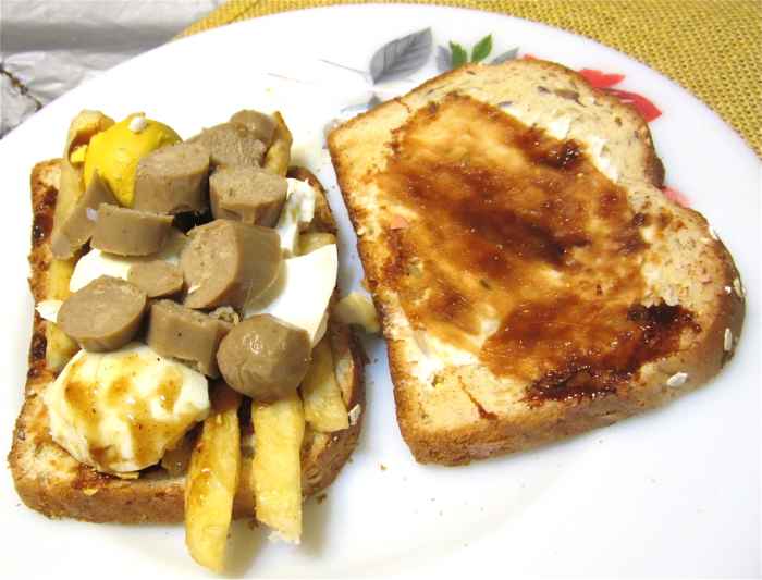 Textured vegetable protein sausage with egg, French fries, and marmite