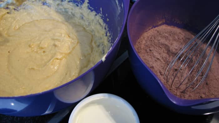 Add the flour/cocoa mixture and sour cream to the creamed butter/sugar/eggs in three alternating lots.
