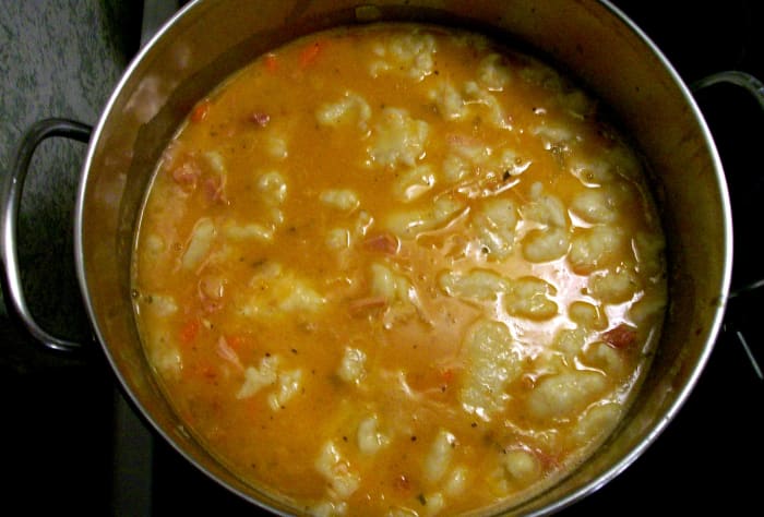 Once the dumplings are floating at the top in the plain water, use a slated spoon to remove them and place them directly into the soup pot.