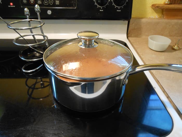 Whole grain brown Spanish rice should simmer in tomato sauce, water, and spices for 45–50 minutes.