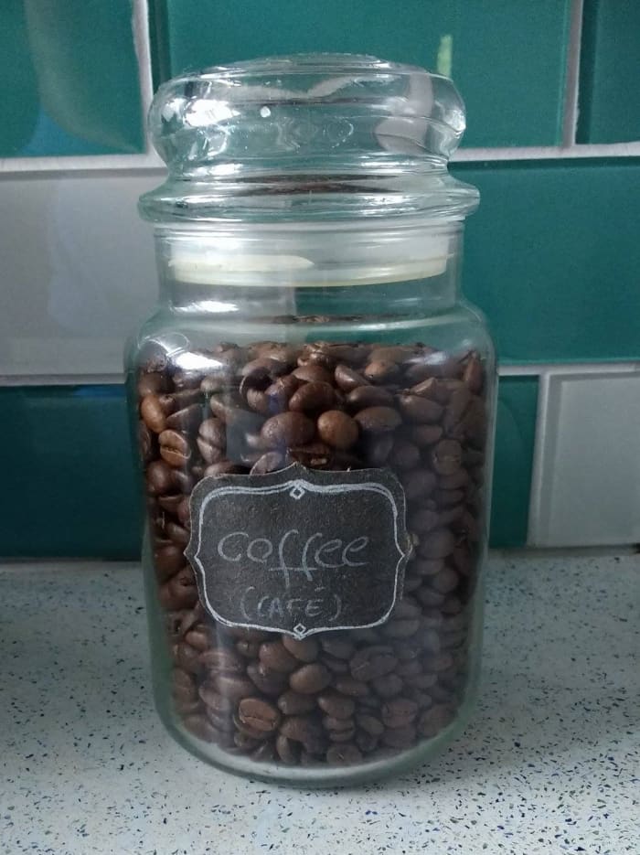 My own coffee storage jar. Made of glass, the airtight lid seals the flavor in and protects the beans from moisture. When not in use, I store the jar in a cool and dark cupboard above the kitchen counter.