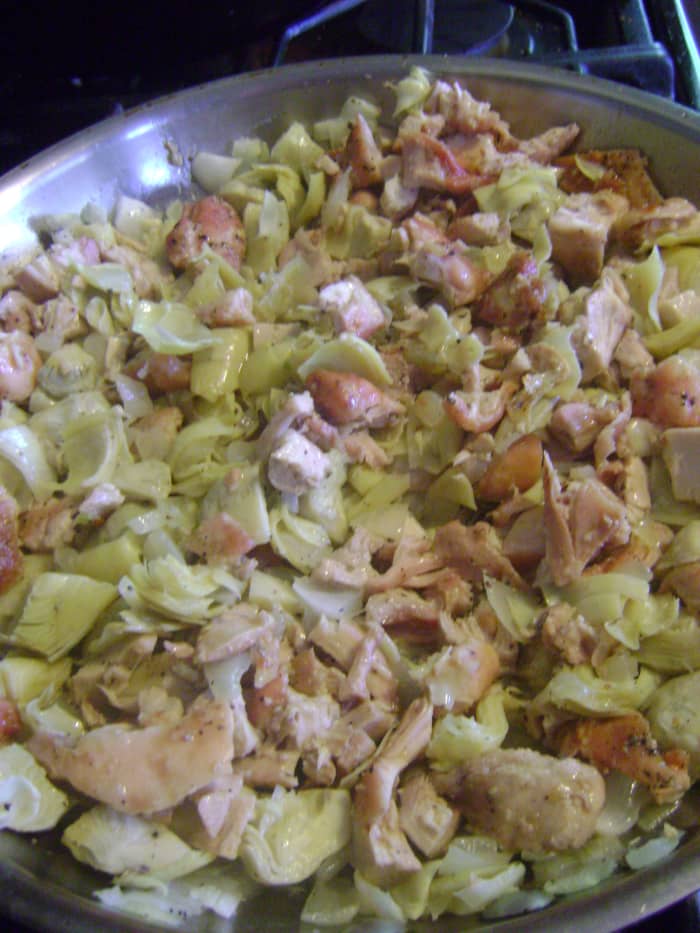 Sauteing the mixture allows all of the flavors of the garlic, onions, artichokes and chicken to marry before going into the casserole