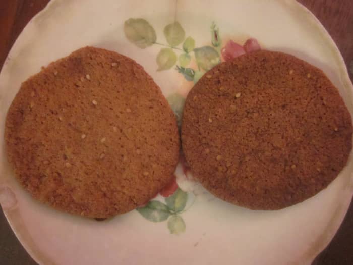 The cookie on the left is crunchy on the edges and chewy in the middle. The darker cookie on the right has been cooked until it is completely crunchy.