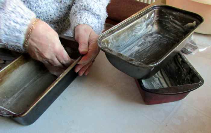 Grease the baking tins for baking bread