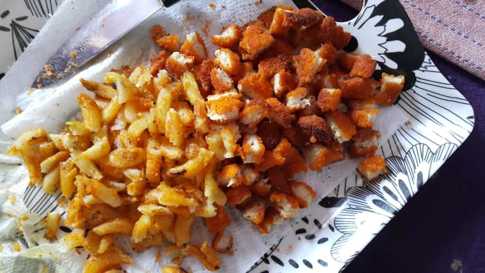 Once fried, break the chicken nuggets and curly fries into small pieces as shown in the picture.