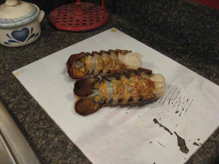 Rinse and dry the lobster tails and place them on a cutting board.