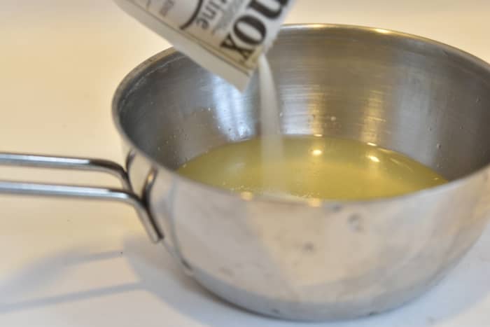 Step 2: Sprinkle the gelatin into the liquids and stir well. Start by pouring the gelatin powder into the juice mixture.