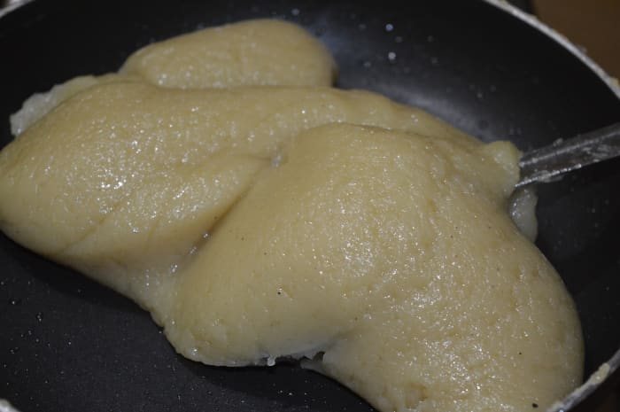 Add the remaining ghee. This is the last stage of cooking this sweet. The mix comes together like a single mass.