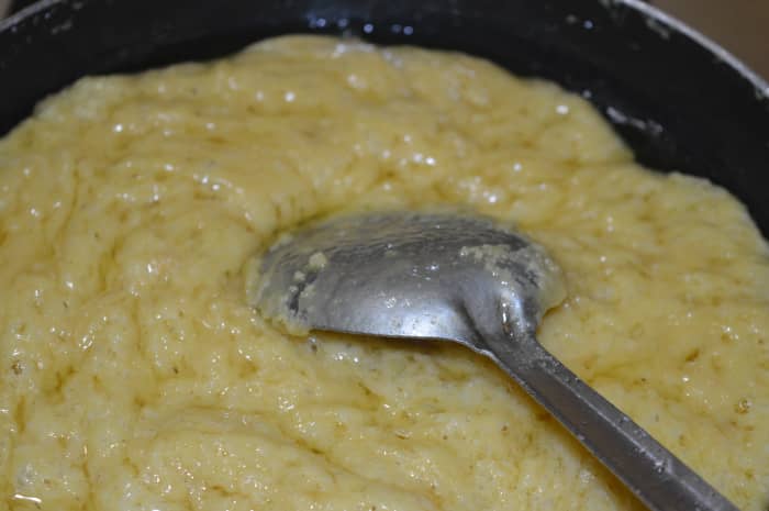 Step 11: Keep stirring until the mix appears porous. See how the entire mix has become porous and froth-like? This is the right consistency to transfer it into the greased tray.