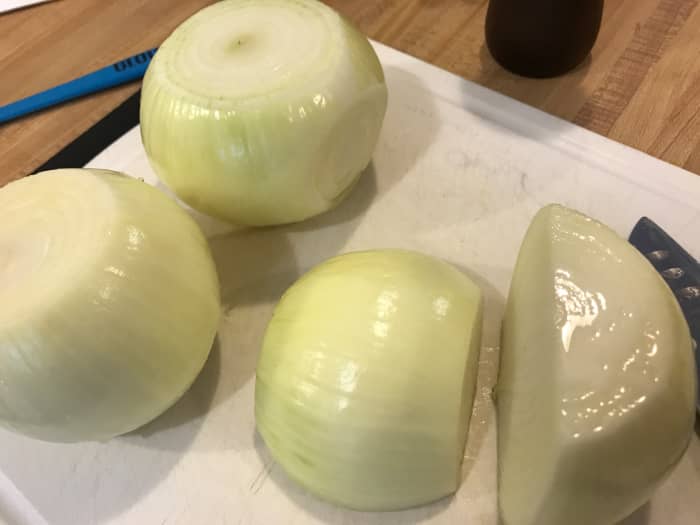 You can use any cut of onion for caramelizing, but the most traditional is slices. Cut the onions in half after peeling it to get started.