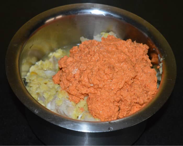 Step four: Put lentil\jackfruit mix and masala paste to a vessel. Add some water, turmeric powder, tamarind paste, a small jaggery piece, and some salt. Turn the mixture.