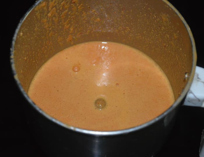 Step two: Put grated coconut, mustard seeds, and dry red chilies in a mixer or blender. Grind, adding some water, to get a smooth sauce. Transfer it to the mixing bowl.