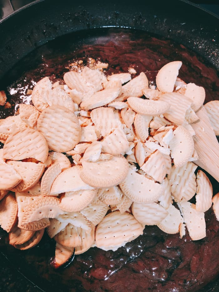 Lastly, add the biscuits. (Crack the biscuits into small pieces before putting into the chocolate mixture).