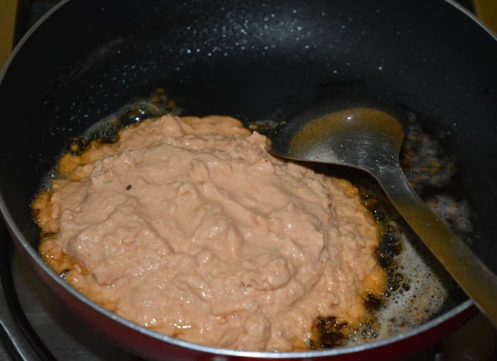 Step two: Heat oil in a non-stick pan. Throw in cumin seeds. Let them crackle. Add cashew paste. Saute until oil separates from it.