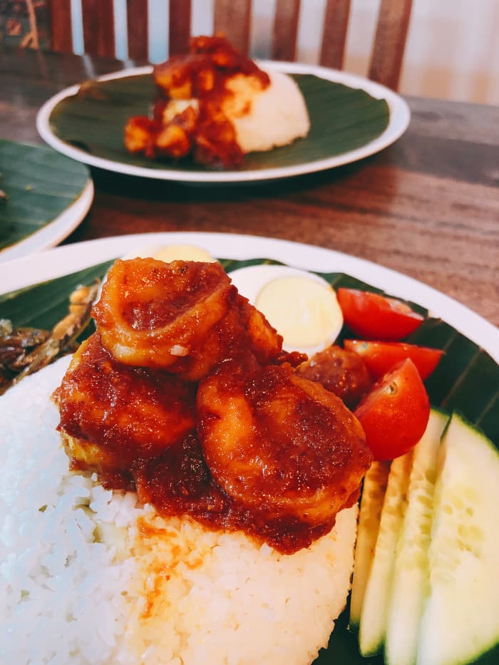Nasi lemak, or fragrant coconut rice, is known for the aromatic smell of fresh, green pandan leaves and the light flavor of sweet and creamy coconut milk. Pandan leaves are commonly used for coloring and flavoring in Southeast Asian cuisine.