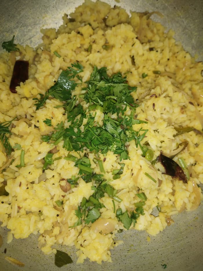 Mix everything properly. Cover and let sit on flame for 1-2 minutes. Garnish with finely chopped fresh coriander leaves. Squeeze lemon and mix well. Serve hot.
