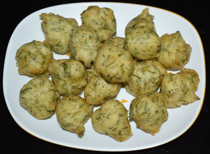 Serve hot with coconut chutney, green chutney, or tomato sauce. Enjoy eating the smoky-flavored fritters!