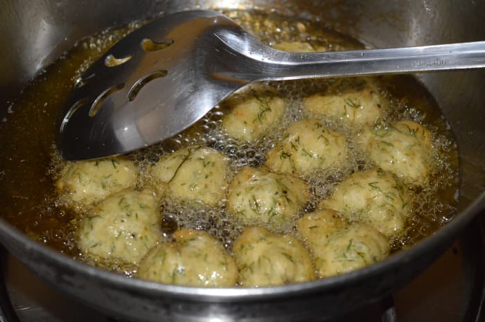 Turn them occasionally to ensure uniform frying. Fry until the fritters are golden brown and crunchy. Remove them onto an absorbent paper towel.
