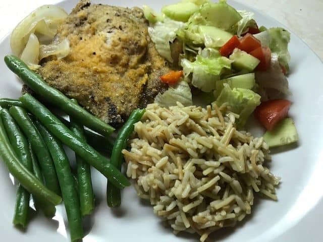 Garlicky pork chops served with green beans, rice, and a garden salad. Dinner is served!