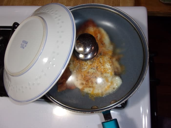 I like to prop my plate against the skillet to warm it. Use a pot holder to lift it. It may be quite hot!