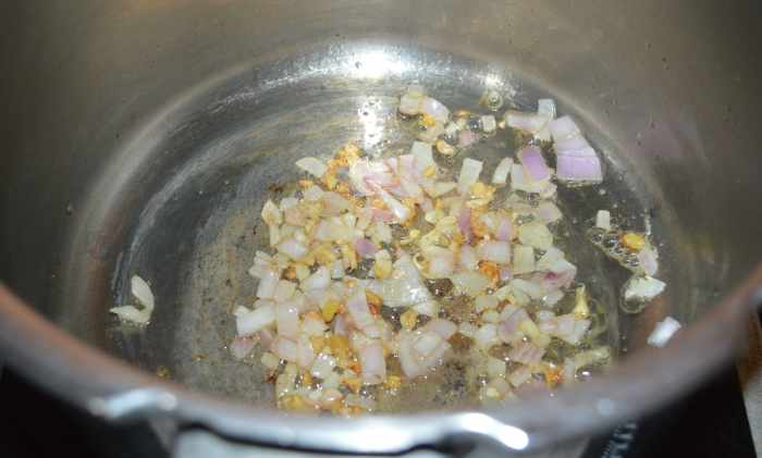 Step one: Heat oil in a pressure cooker. Add minced ginger and garlic. Saute for 1 minute. Add chopped onion. Continue sauteing until the onions become pinkish.