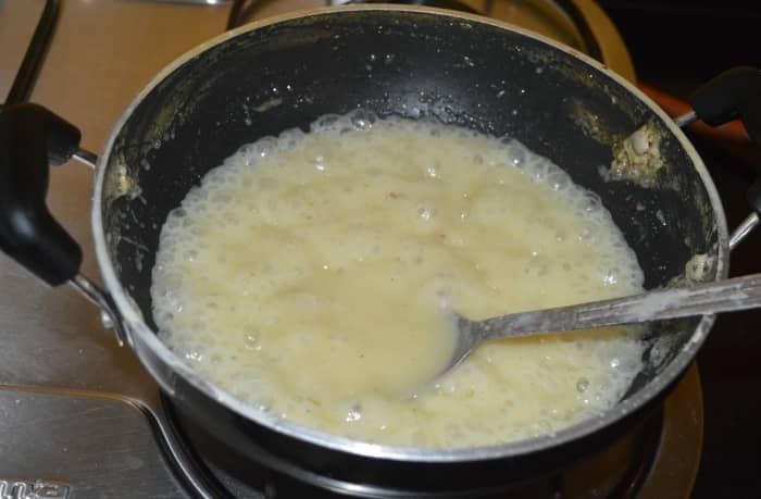 After some time, the mixture will change its color and start to thicken. At this point, reduce the heat to a medium-low and continuously stir it.