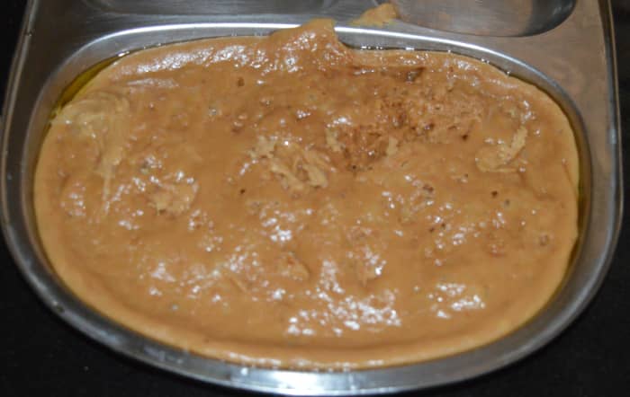 Turn off the heat and pour the hot mixture into a greased rectangle container or plate. Allow it to cool. While it is still hot, make shallow criss-cross lines on it with a knife so that you can cut it on the lines later.