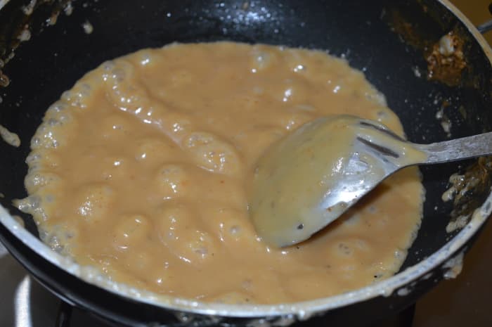 Step three: After about 20 minutes, the mixture will thicken and become biscuit-colored. Stir it continuously until the mixture becomes completely porous, light, and comes out as a single lump leaving the bottom.
