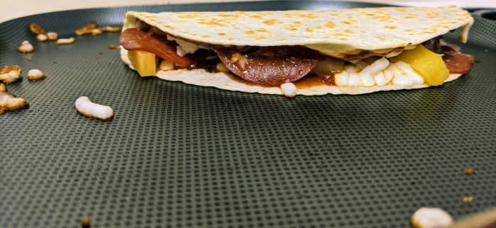The desired crispiness of the outside of a pizzadilla is a personal preference. I prefer a little crunch but not so much that the tortilla cracks when folded.