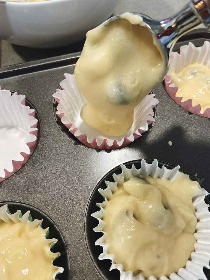 Use an ice-cream scoop to fill the muffins cups. 