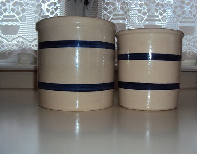A ceramic pot is good for use as a crock. A metal pot leaches metal molecules into the mix and produces an off flavor..