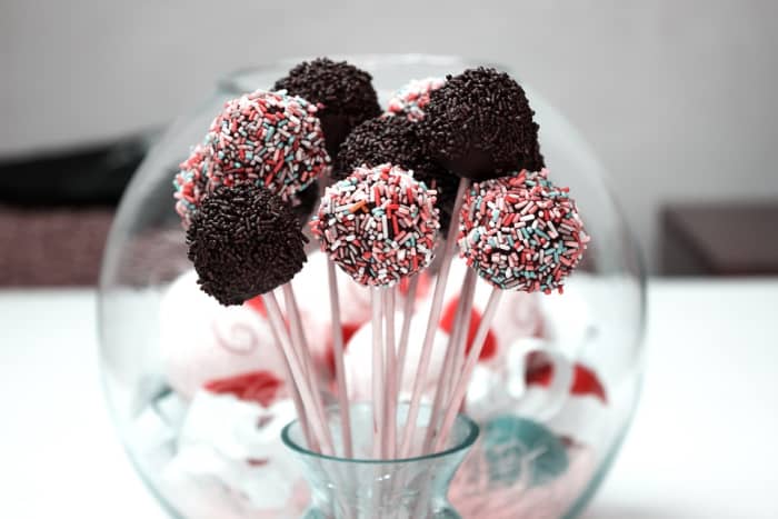 Roll rum balls in candy sprinkles or powdered sugar and place onto lollipop sticks for a party.