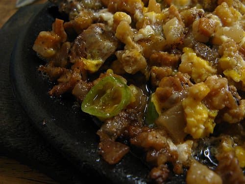 Traditional pork sisig, sauteed in a variety of spices, with sliced long green peppers
