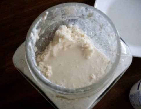 Butter has formed. This shows the separation of butter and buttermilk. The butter here looks somewhat lumpy, because it's been whipped around, but you'll want to compare the texture of your finished product to the cream with which you started.