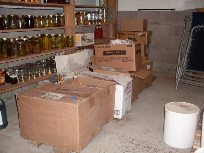 This is a very nice cellar. It was designed with the total needs of the farm in mind, so it has lots of room for canned and fresh goods. The boxes in the center contain beets, carrots, turnips, rutabagas, and potatoes.