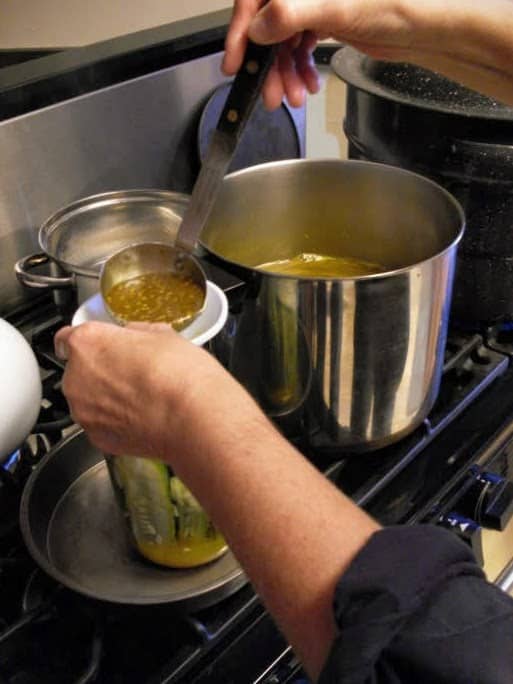 Ladle hot solution over cucumbers, leaving a 1/2-inch headspace. Wipe rim of jar with clean, damp cloth or paper towel.