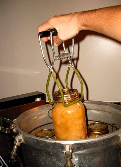 Lift each jar out carefully with a jar lifter. If you have waited for the canner to cool sufficiently, you should be able to remove the jars promptly.