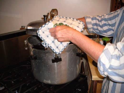 DO NOT REMOVE WEIGHT YET. Once the pressure gauge has returned to zero pounds, carefully remove the weight and lid of your canner. Unscrew knobs in opposites, just like you tightened them.