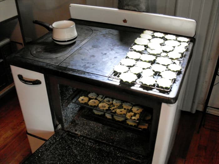 An old-fashioned cookstove is superb for drying vegetables. I have one load on top on the just-warm side, starting the process, and a tray inside, almost finished.