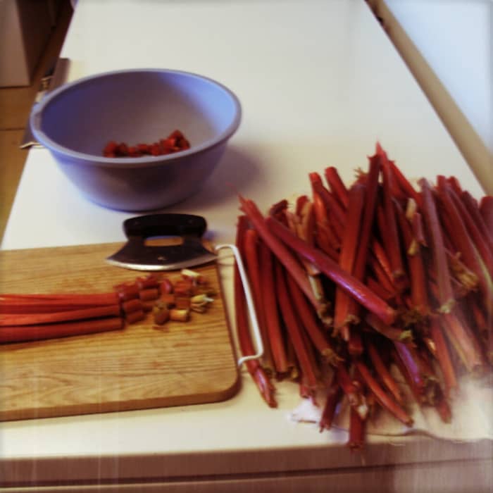 Rhubarb is largely water and may usually be chopped coursely, as it cooks down a lot. 1/2" pieces are good for pies, 1/4" for cakes or breads. Split thick stalks lengthwise, then lay 3 or 4 together, and chop. Peel only as necessary.