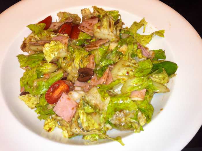 The big arsed salad with romaine, grape tomatoes, kalamata olives, and dressing made with balsamic vinegar.