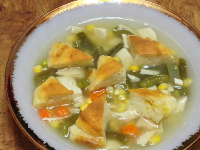 Chicken & "dumpling" soup with diced chicken, mixed vegetables, chicken broth, and biscuit "dumplings."