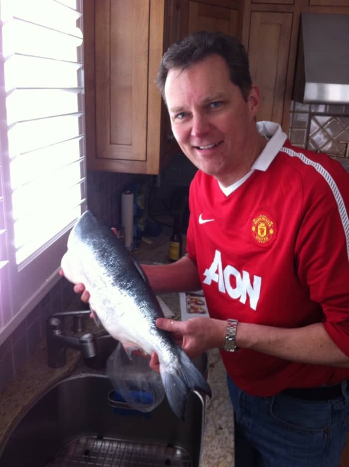 The first step is washing the salmon under cold water and patting it dry on the inside and outside with paper towels