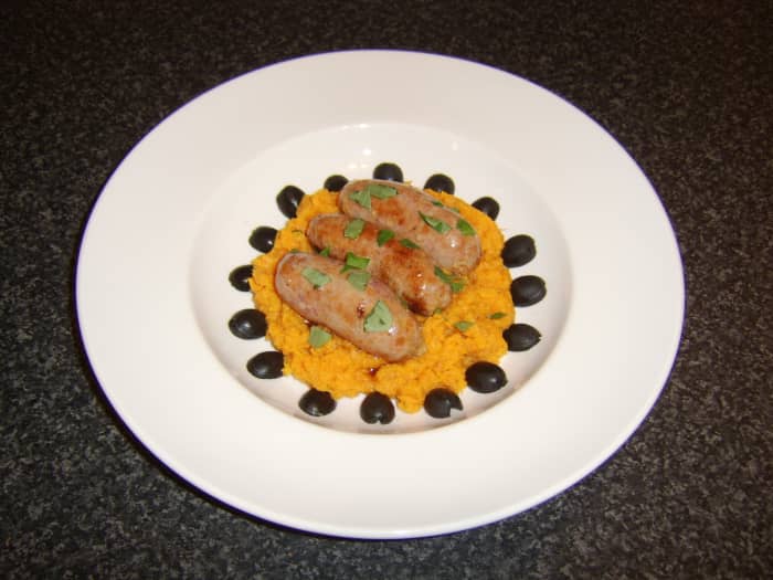 A ring of black olive halves make an attractive final garnish for this Mediterranean style bangers and mash