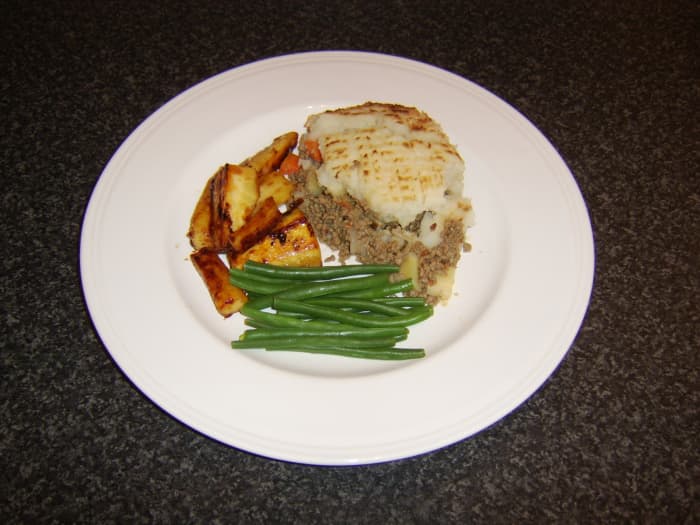 The whisky marmalade roast parsnips are served with a portion of cottage pie and blanched green beans
