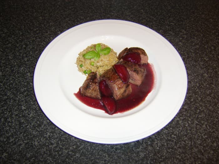This oven-roasted duck breast is sliced, topped with plum and ginger sauce, and served with fried rice