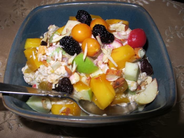 Make Bircher's Swiss muesli with any fruit you have on hand. Pictured: muesli with apples, mangoes, berries, and almond slivers.