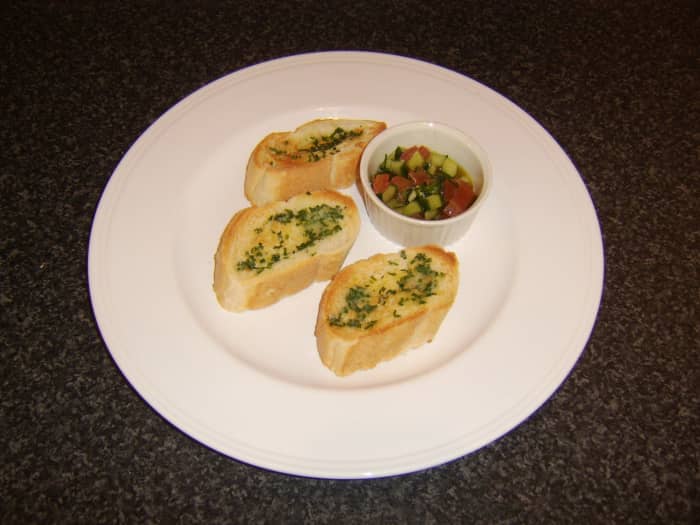 The chive and garlic butter is spread on hot toast and served with a small ramekin of simple salsa as a tasty snack or starter.