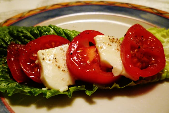 Salad Caprese - Herbes de Provence EVOO drizzled over sliced tomatoes & fresh mozarella cheese.